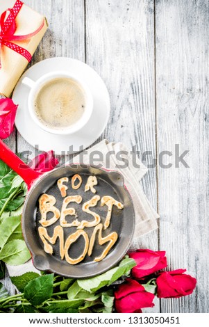 Mother's day greeting background concept, with red rose flowers, greeting card creative pancakes for best mom, i love mom, and coffee mug, wooden background copy space