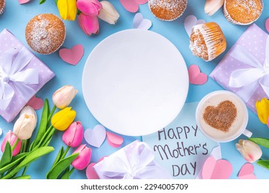 Mother's day holiday greeting card. Mother's Day morning breakfast with a cute surprise background, with gift boxes, cupcakes, coffee mug, heart decor, tulips and flowers, Happy Mother's Day letter - Powered by Shutterstock