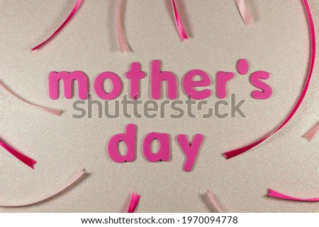 Mother's Day Text With Pink Ribbons On Glitter Background