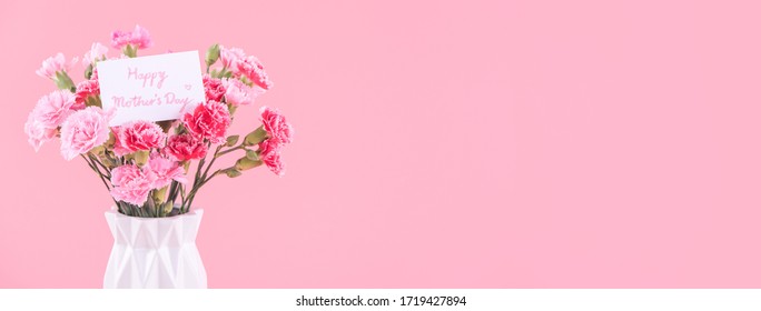 Mother's Day, Valentine's Day holiday gift design concept, pink carnation flower bouquet with wrapped box isolated on light pink background, copy space. - Powered by Shutterstock