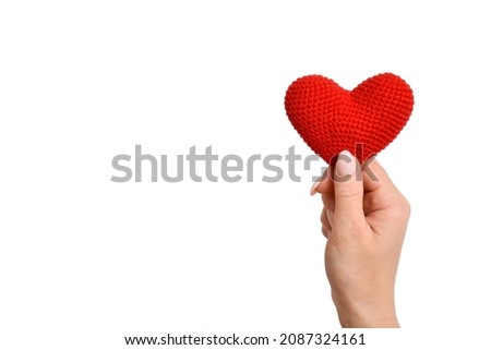 Mother's Day. Women's hands hold a knitted heart. Mother's love. International Family Day. A holiday card. Copy space.