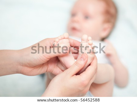 Mothers hand and the Baby`s Feet - indoors shoot
