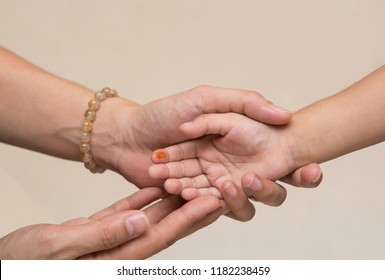 Mother's hand holding baby'hand with a wound on her finger,Abrasion,bleeding