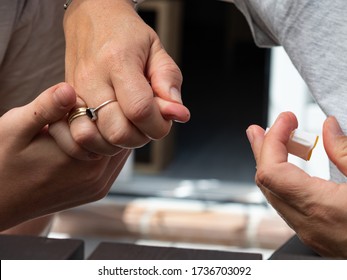 A MOTHER'S HAND PRICKING HER CHILD'S FINGER FOR A COVID SEROLOGICAL TEST