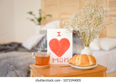 Mother's Morning breakfast on wooden tray near bed with greeting card I love you mom. Mother's Day concept. - Powered by Shutterstock
