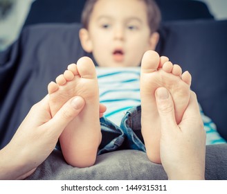 Mother/therapist massaging her child's foot, shallow focus. Close up photo - Powered by Shutterstock