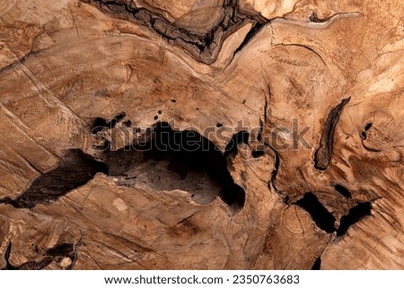 motif on a piece of wood, where there is a hole like weathered wood