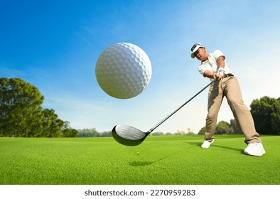 Motion action of golfer teeing off with drivers.