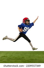 In Motion. Athletic Kid, Beginner American Football Player In Sports Uniform And Helmet Training Isolated On White Background. Concept Of Sport, Challenges, Action, Achievements.