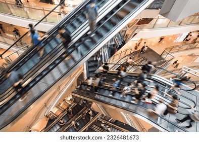Motion blur Asian people customer transport on escalator at urban shopping mall in Hong Kong. Department store business, financial economy, Asia city life, tourist traveler lifestyle. High angle view