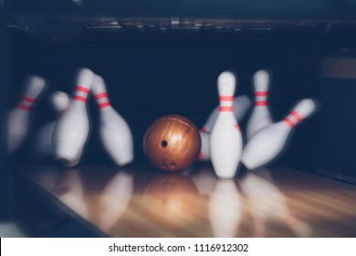 Motion Blur Of Bowling Ball And Skittles On The Playing Field