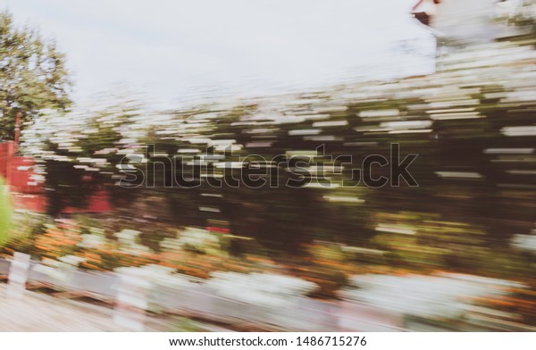 Motion blur of bushes and\
house
