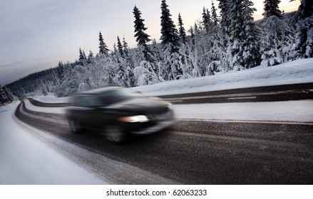 Motion Blur of Car Driving Down Snow Covered Road