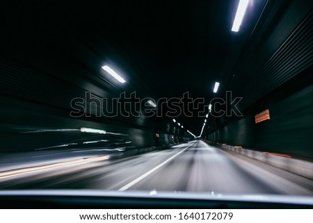 Motion blur of car moving inside tunnel