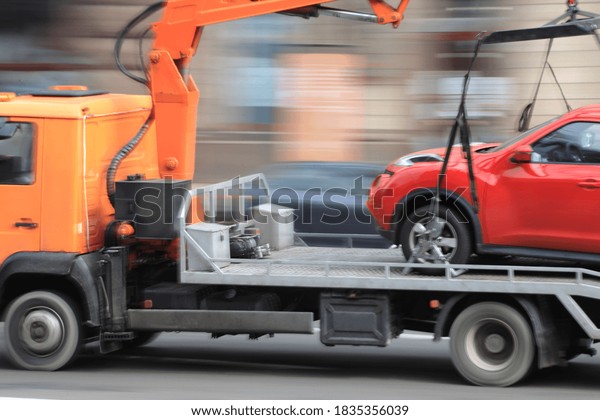 Motion blur,\
car tow truck rides on a city\
street