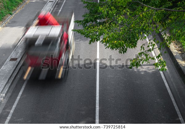 Motion blur of cars in\
aerial view over the road. (Speed limits - Infractions - Speed\
Cameras)