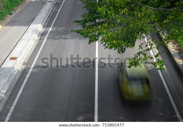 Motion blur of cars in\
aerial view over the road. (Speed limits - Infractions - Speed\
Cameras)