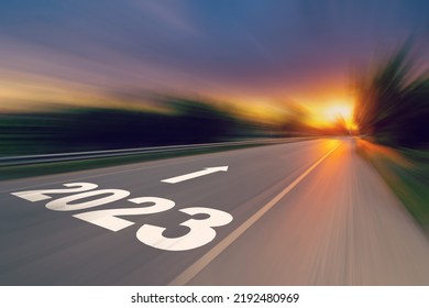 Motion blur empty asphalt road and New year 2023 concept. Driving on an empty road to Goals 2023 with sunset. - Shutterstock ID 2192480969