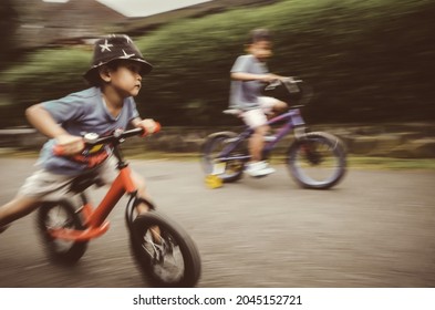 motion blur, face of a boy on his bicycle - Shutterstock ID 2045152721