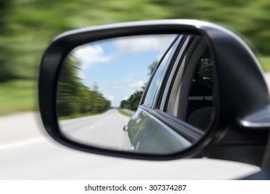 Motion Blur Image Of Street From The Sideview Mirror