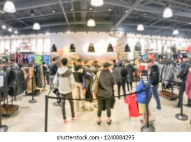 Motion Blur Long Line Of Diverse Customers Waiting To Checkout At Activewear, Outdoor Gear Store In Texas, USA. Defocused Abstract Crowed People Retractable Stanchions Queue Barrier, Holiday Shopping