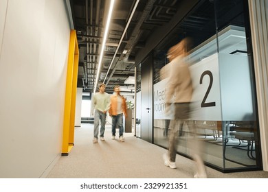 motion blur of modern business people working in corridor along meeting room in contemporary coworking environment with high tech interior, dynamic business concept - Powered by Shutterstock