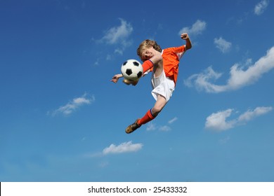 (MOTION BLUR ON FEET AND BALL) young boy, football player doing amazing kick - Powered by Shutterstock