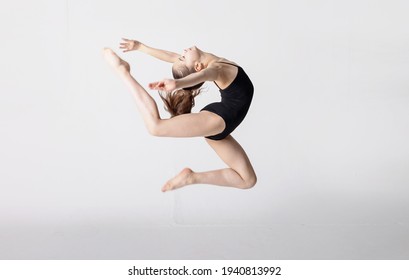 motion blur photo preteen girl gymnast trains on white background in black leotard. children's professional sports. rhythmic gymnastics. 