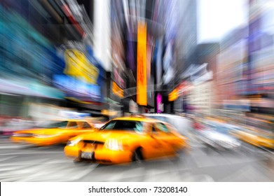 Motion Blur Photo Of Yellow Taxi Cabs Rushing On Broadway Road In Times Square During Rush Hour In Midtown Manhattan, New York City, New York USA.Colorful Abstract Background. No People. Copy Space