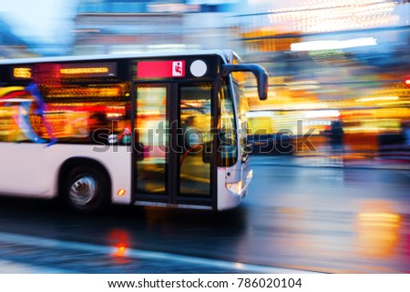 motion blur picture of a driving bus in the city at night