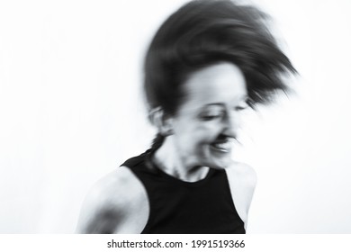 Motion Blur Portrait Of Woman Over 40. Black Tshirt