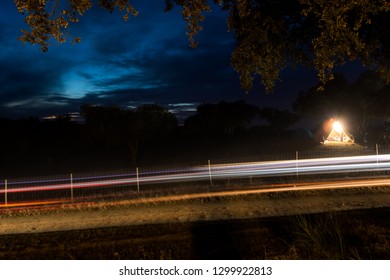 Motion Blur Of A Rally Car Lights Undertaken On A Racetrack At Night / Dusk During Rally 24 Hours Fronteira, Portugal