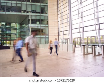 Motion Blur Shot Of Businesspeople In Lobby Of Busy Modern Office