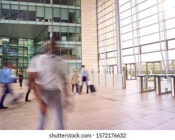 Motion Blur Shot Of Businesspeople In Lobby Of Busy Modern Office