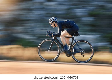 Motion blur, speed and cyclist on bicycle on road in mountain with helmet, exercise adventure trail and fitness. Cycling race, nature and man with bike for fast workout, training motivation or energy - Powered by Shutterstock