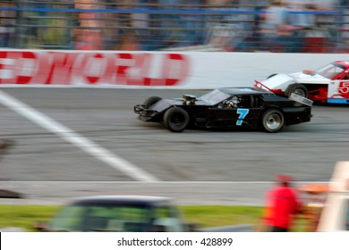 Motion Blur Of Stock Car Race Cars Crossing The Finish Line