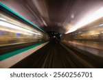 Motion blur of a subway tunnel. Motion-blurred photo from a subway car. Oncoming train, tunnel and station lights are blurred. Subway train going through a tunnel, view from the front train carriage.