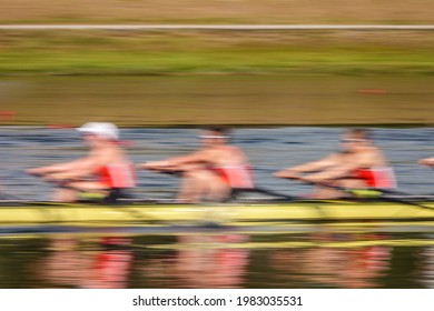 Motion Blur Of Three Collegiate Women Crew Rowers In A Race