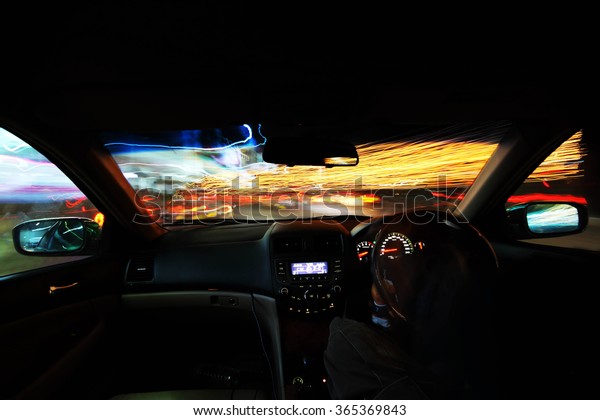 motion blur  of the\
vehicle and light
