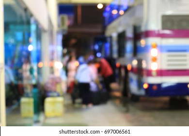 Motion Blurred Abstract Background Of People Waiting For A Bus And Talking Their Luggage To The Bus Service At The Bus Station, Bangkok, Thailand, A City At Night With Blurred Night Street Background