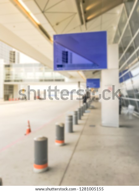 Motion blurred American airport parking garage\
at departure terminal