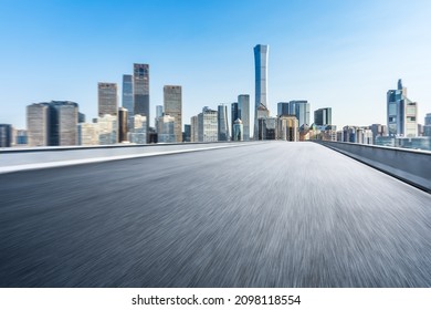 Motion blurred asphalt road and city skyline with buildings in Beijing, China.