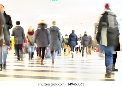 Motion blurred crowd against bright light