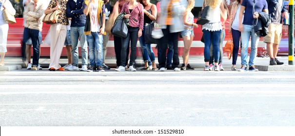 Motion Blurred Crowd Waiting To Cross Street