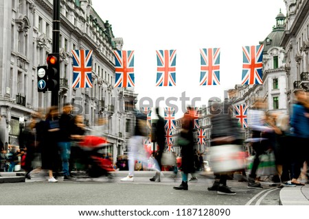 Motion blurred crowds of people on busy London shopping street