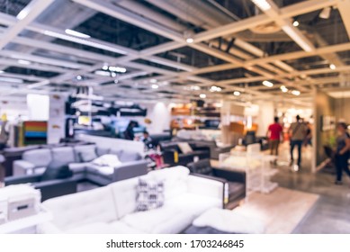 Motion Blurred Customer Shopping For Colorful Sofas And Couches In Different Materials At Furniture Retail Store In Texas, America. Variety Of Furniture In Shapes, Sizes, Styles Modular Or Bed Sofa