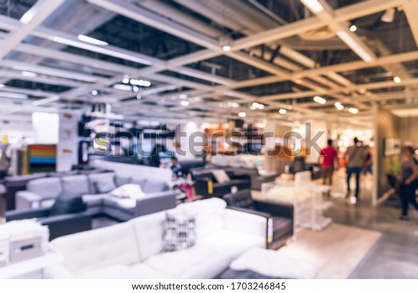 Motion blurred customer shopping for colorful sofas\
and couches in different materials at furniture retail store in\
Texas, America. Variety of furniture in shapes, sizes, styles\
modular or bed sofa