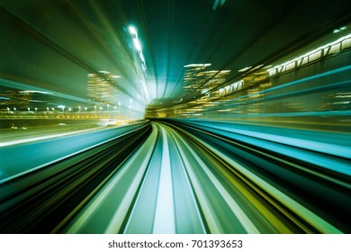 Motion Blurred Front View Of Train Running In Modern City Tunnel. Abstract Transportation Background.