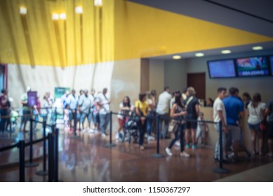 Motion Blurred Long People Queuing At Check-in Counter Entrance Of Museum In Fort Worth. Large Group Of Diverse Multiethnic Visitors Crowd Family Member, Adult, Kid, Toddler Waiting In Separation Line