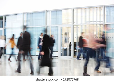 motion blurred people in office building